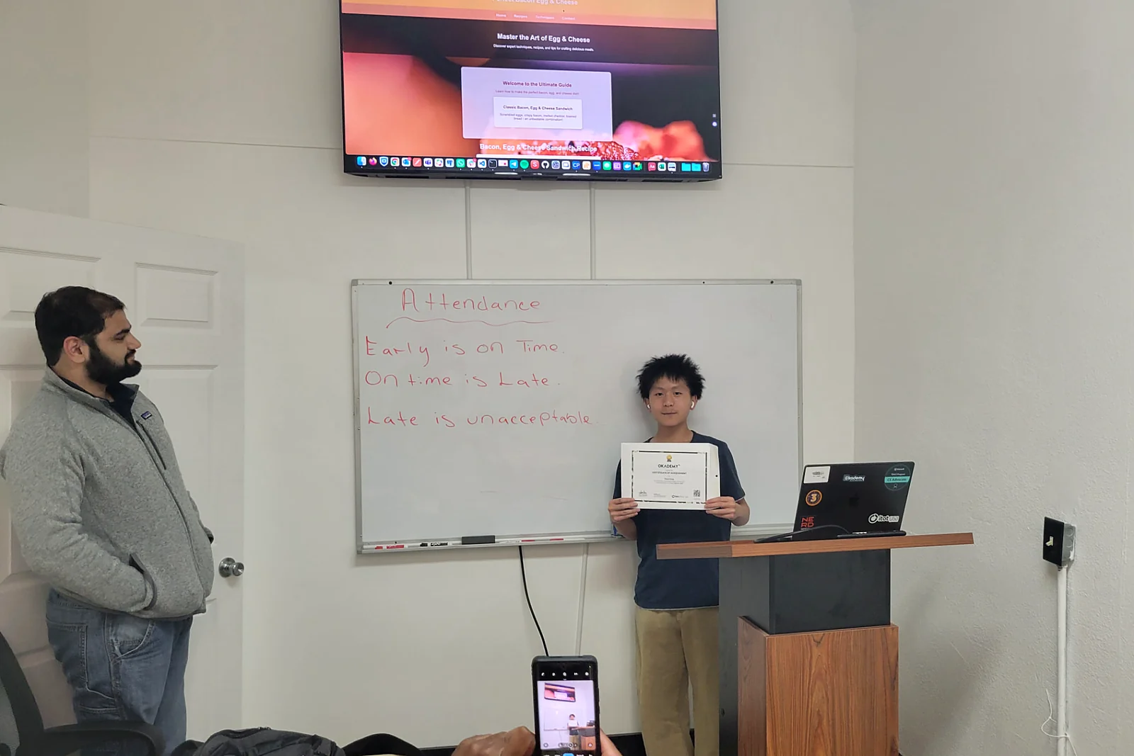 A learner presenting the website he built during an Okademy class