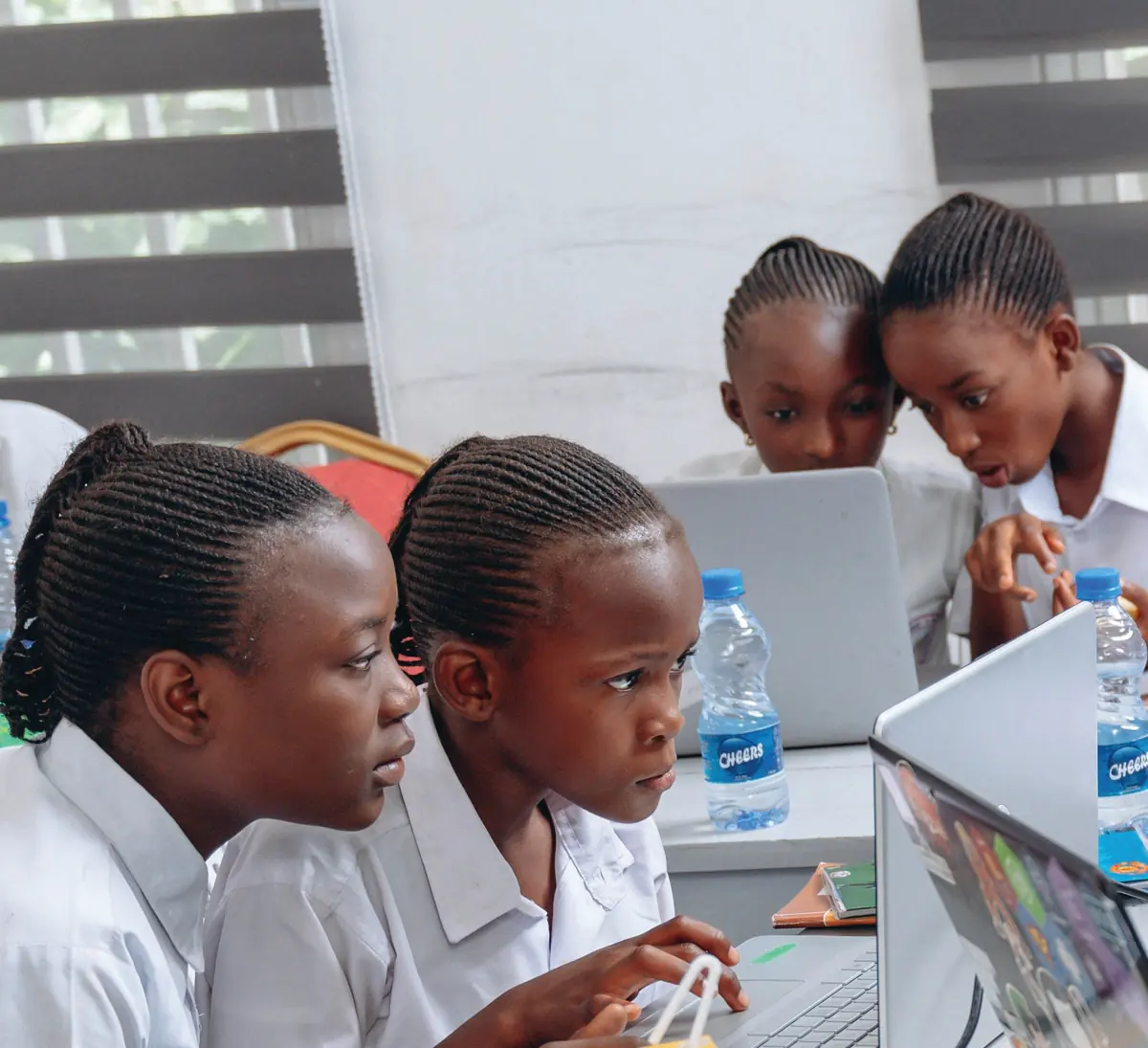 Okademy students building projects on laptops